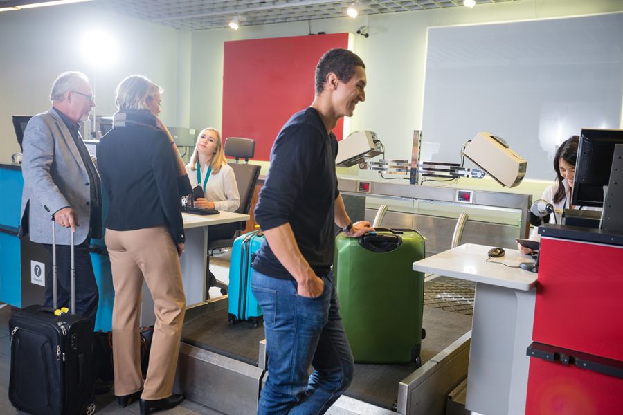 Travelers checking in at a hotel front desk