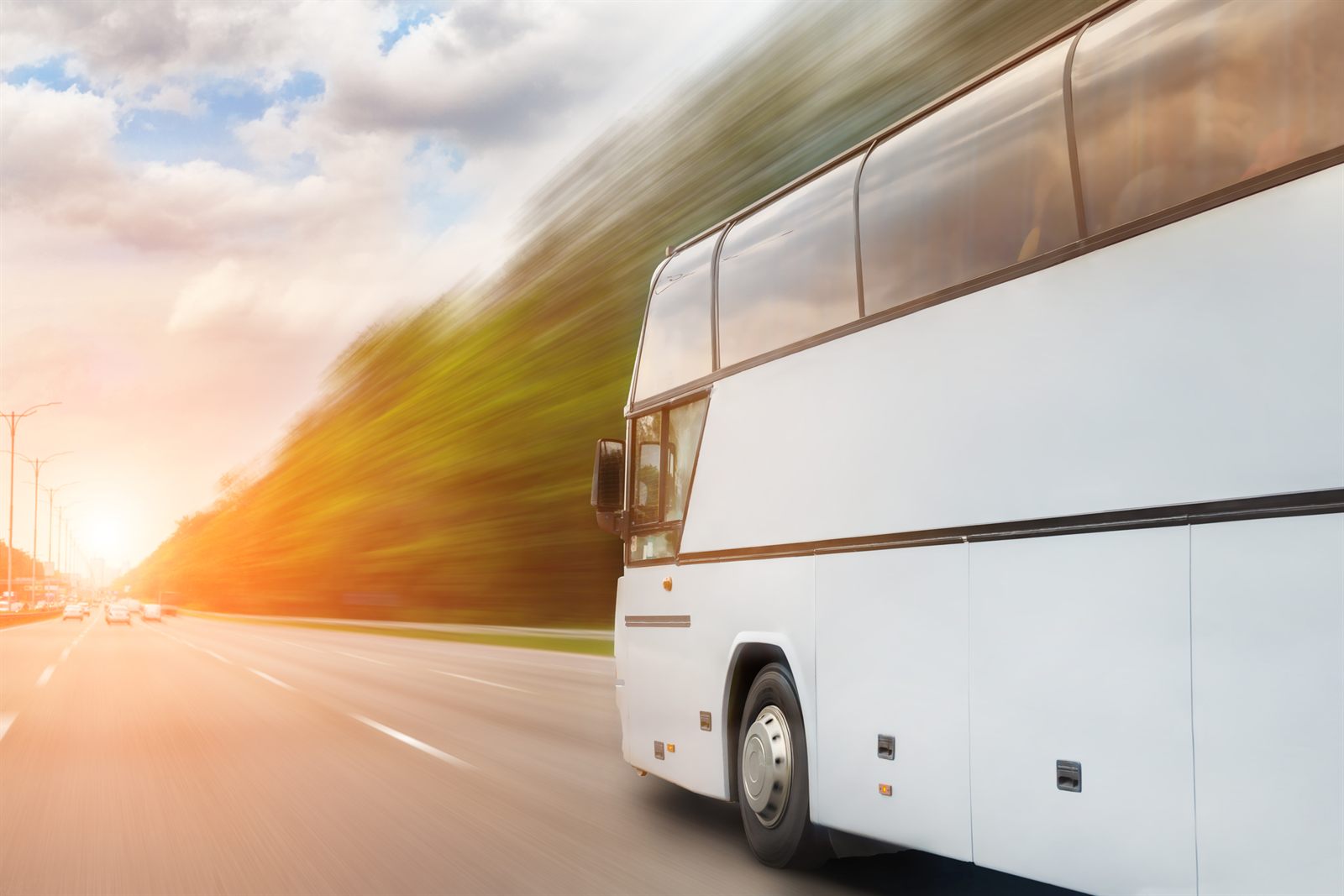 White coach bus traveling along a highway